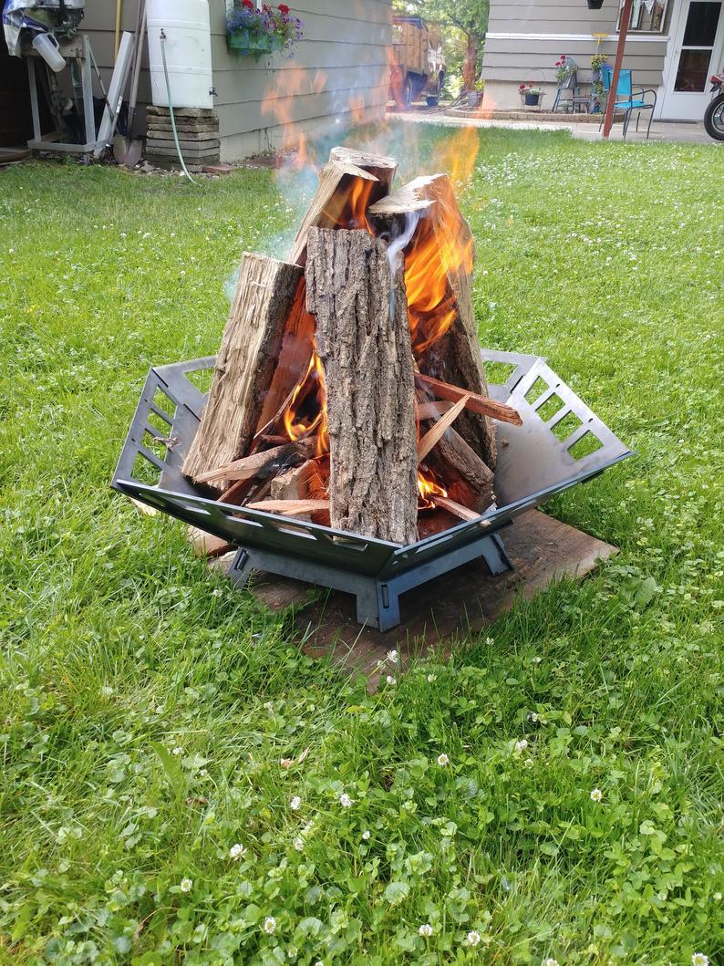 Collapsible Fire pit with logs set like a teepee